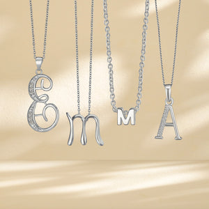 Different letter pendants are hanging down spelling out EMMA.