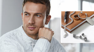 Explore Your Style. Shop Men's Jewelry. Model posing wearing black jewelry and jewelry with Greek patterns.