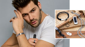 Explore Your Style. Shop Men's Jewelry. Model posing wearing black jewelry and jewelry with Greek patterns.